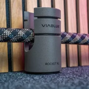 VIA BLUE Rocket XL cable holder on carpet, featuring sleek design and ergonomic grip for organized home theater setup.